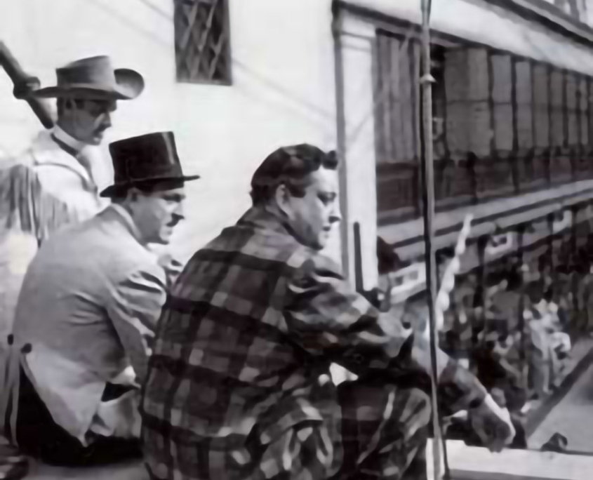 1952 - Jackie Gleason, star of "Honeymoonners"; Jack Sterling, ringmaster of "The Big Top"; and the Range Rider (right to left) as they watch the finish of the 26th annual Macy's Thanksgiving Day Parade.